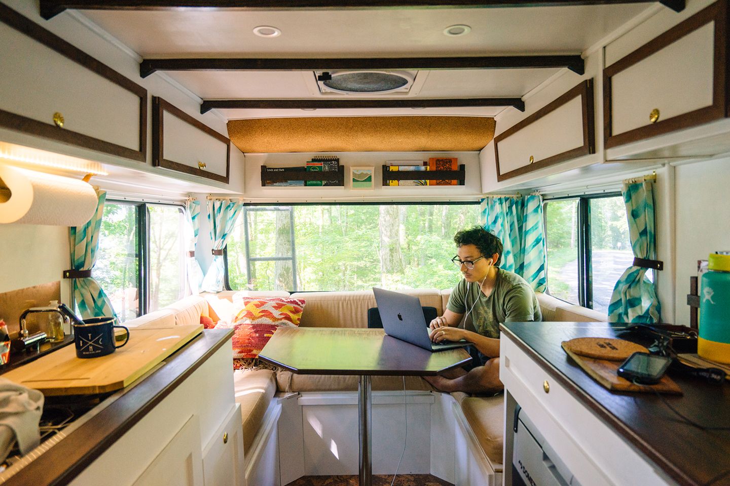 A solopreneur works from the back of an RV, running their business remotely.