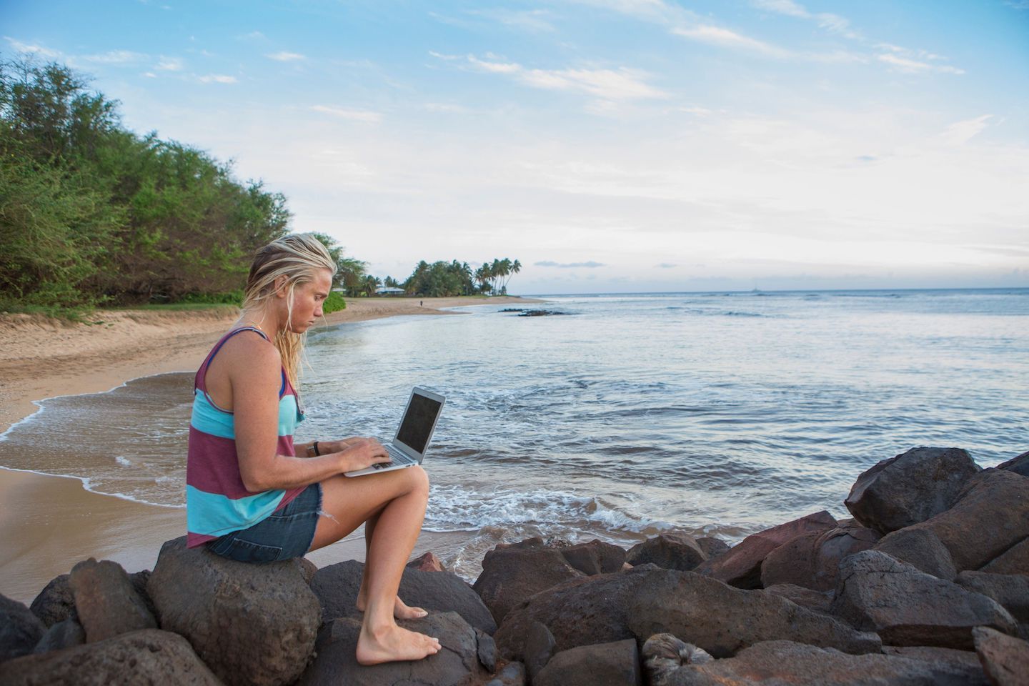 A person using their Windows laptop on the beach to combine two PDF files.