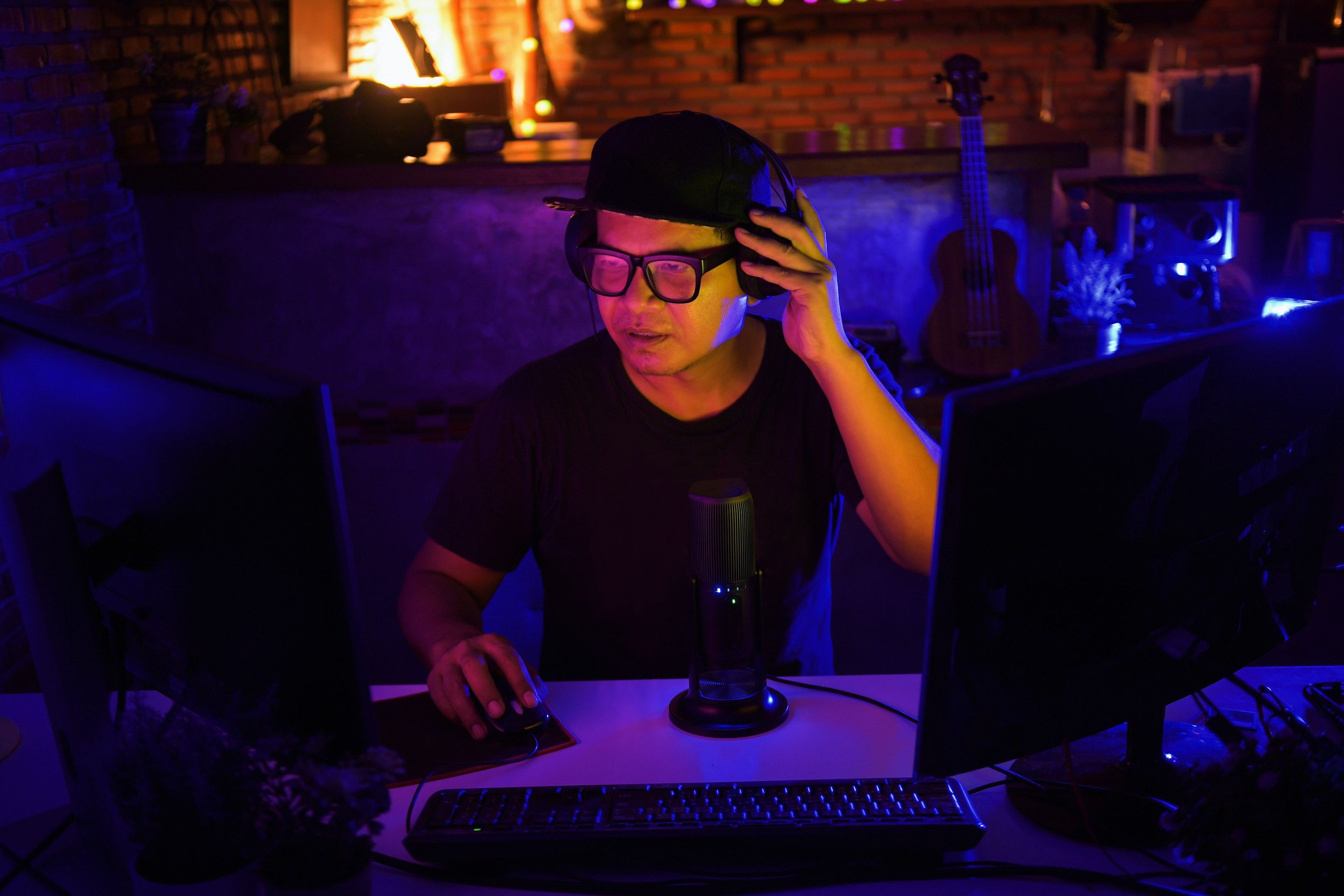 A person records and edits a video presentation using their desktop computer setup.