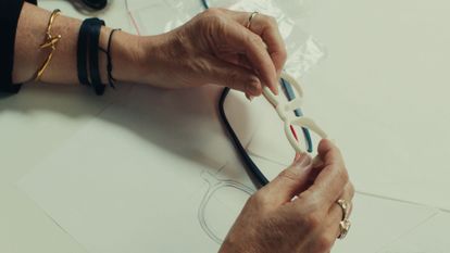 A woman holds a prototype of eyeglasses