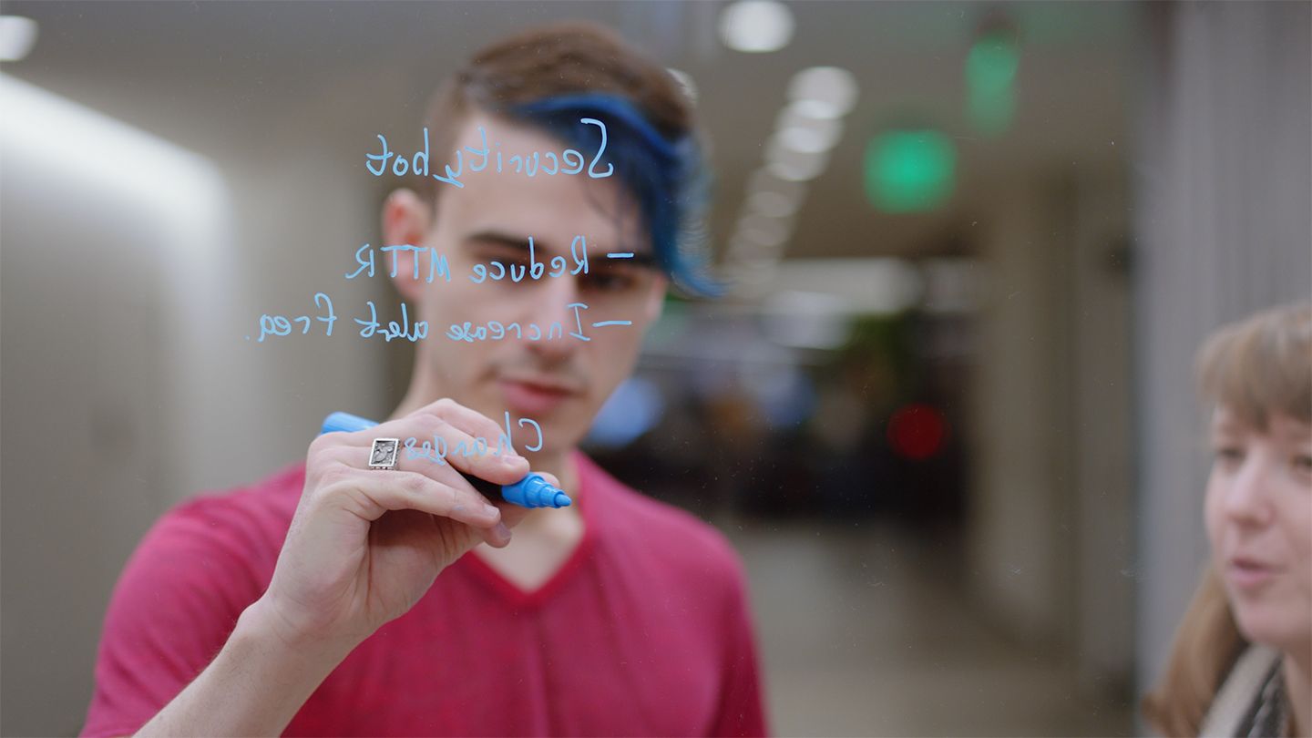 A person writing on a board