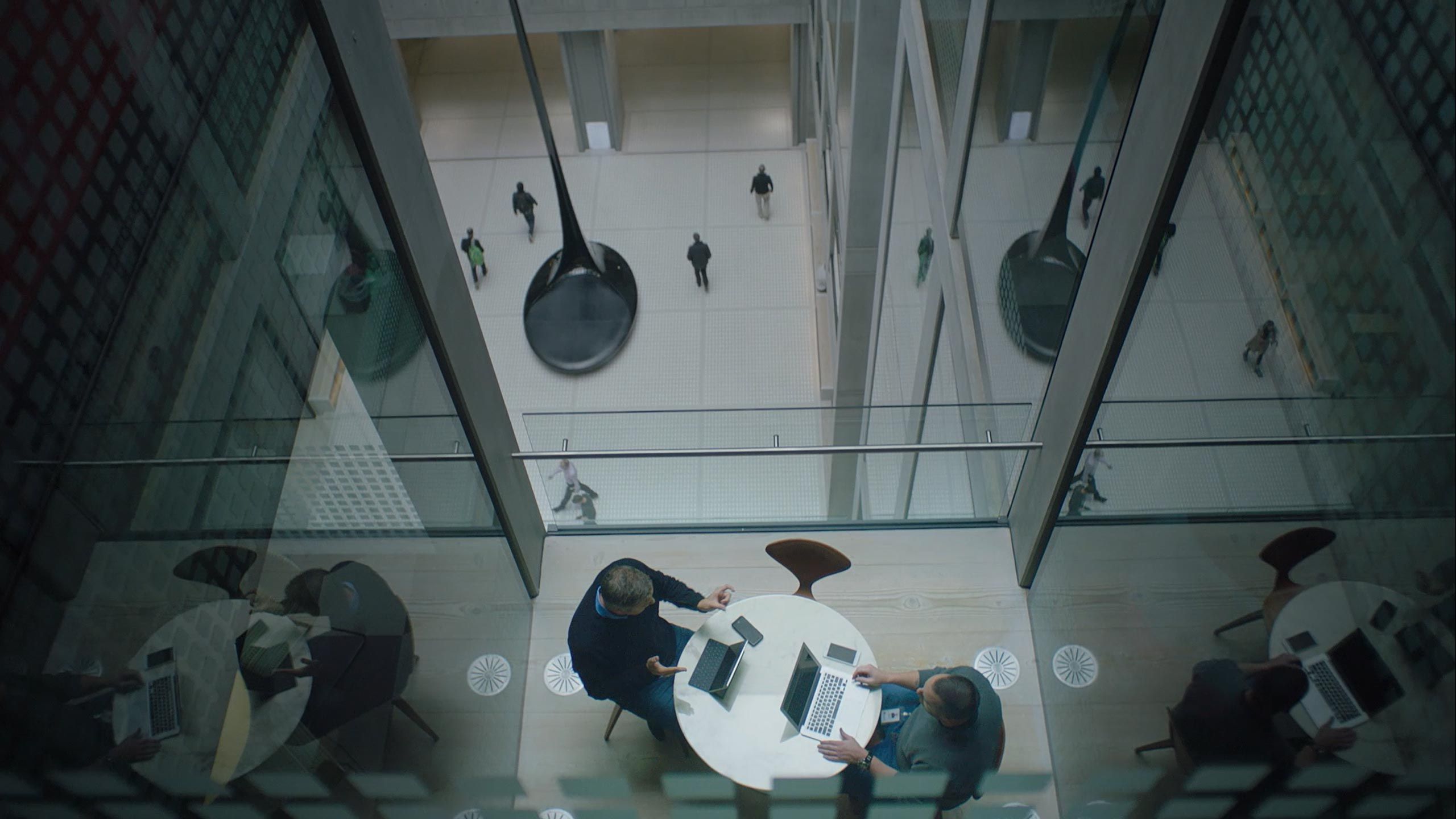 Two people working at a round table in a conference room