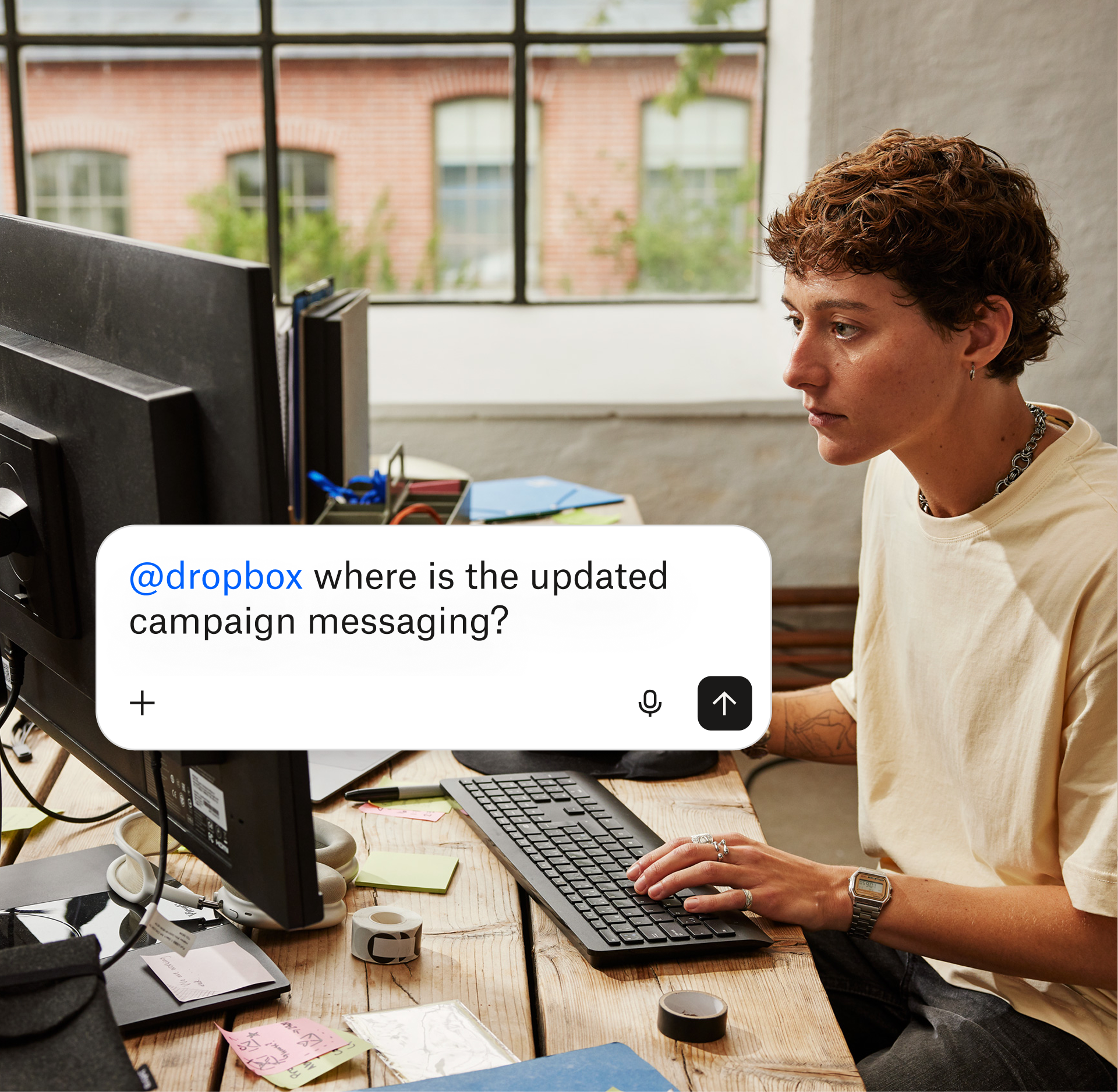 Person at computer asks Dropbox to find updated campaign messaging