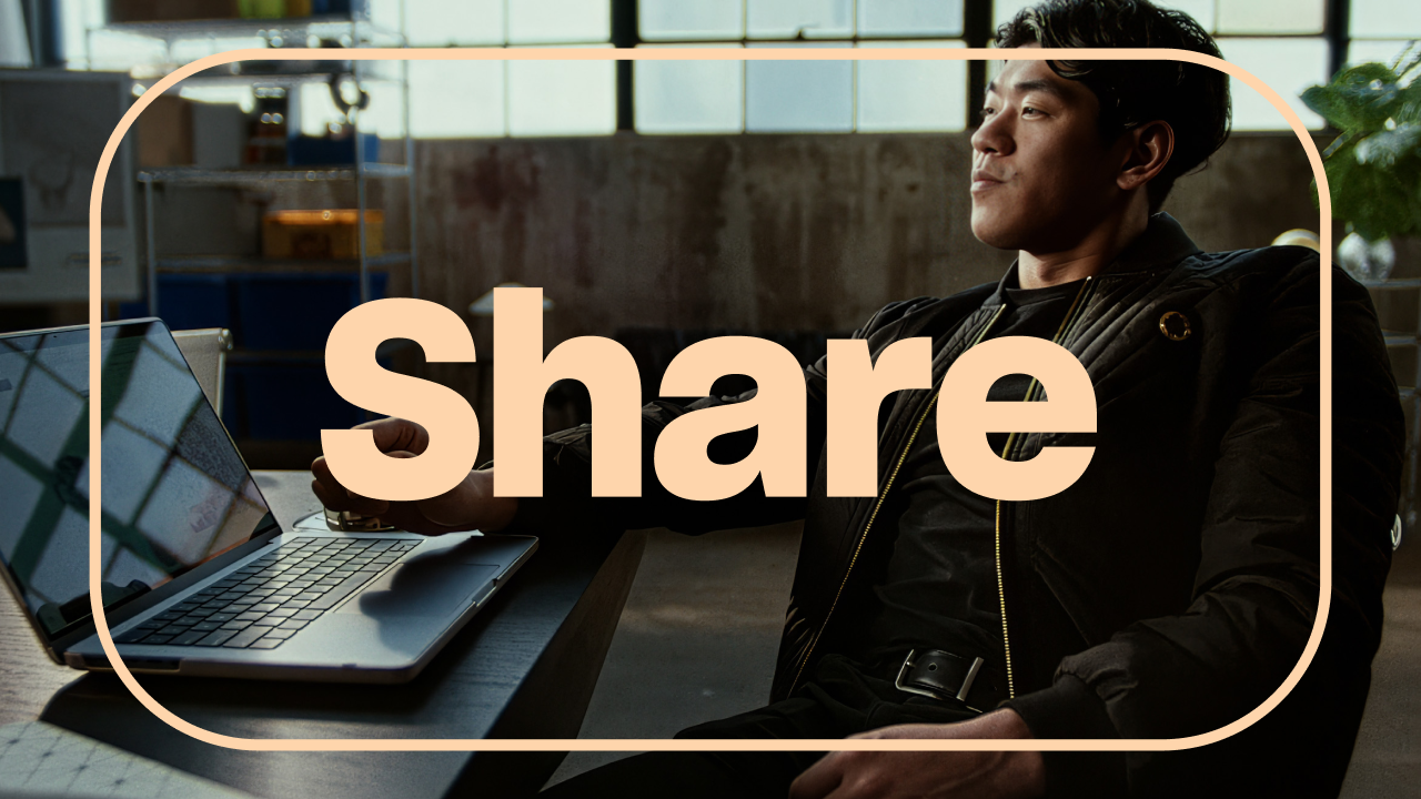 A person seated at a desk beside an open laptop, with the word “Share” in large text across the image.