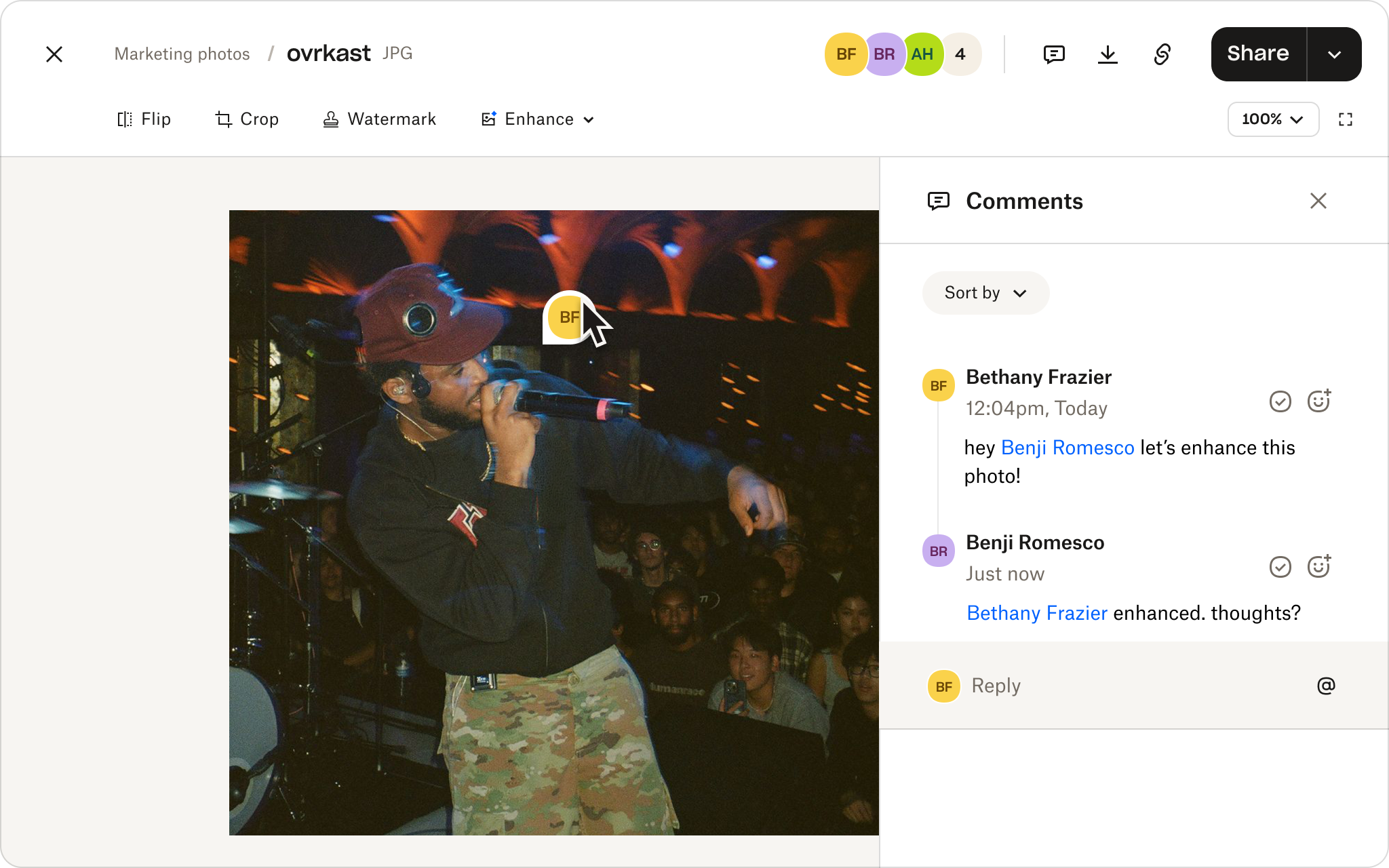 Dropbox image viewer showing a concert photo of a singer performing onstage, with the Comments panel open on the right and two collaborators discussing enhancing the image.