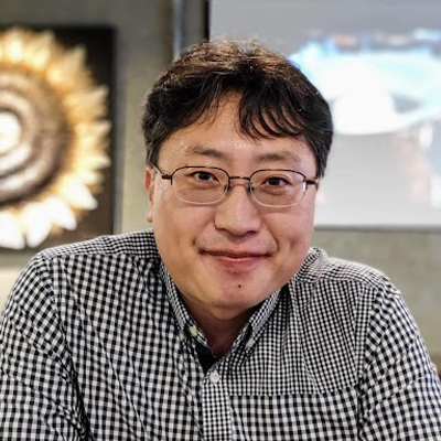 Head shot of Shin Kyung-chul, Korean man with dark hair wearing glasses