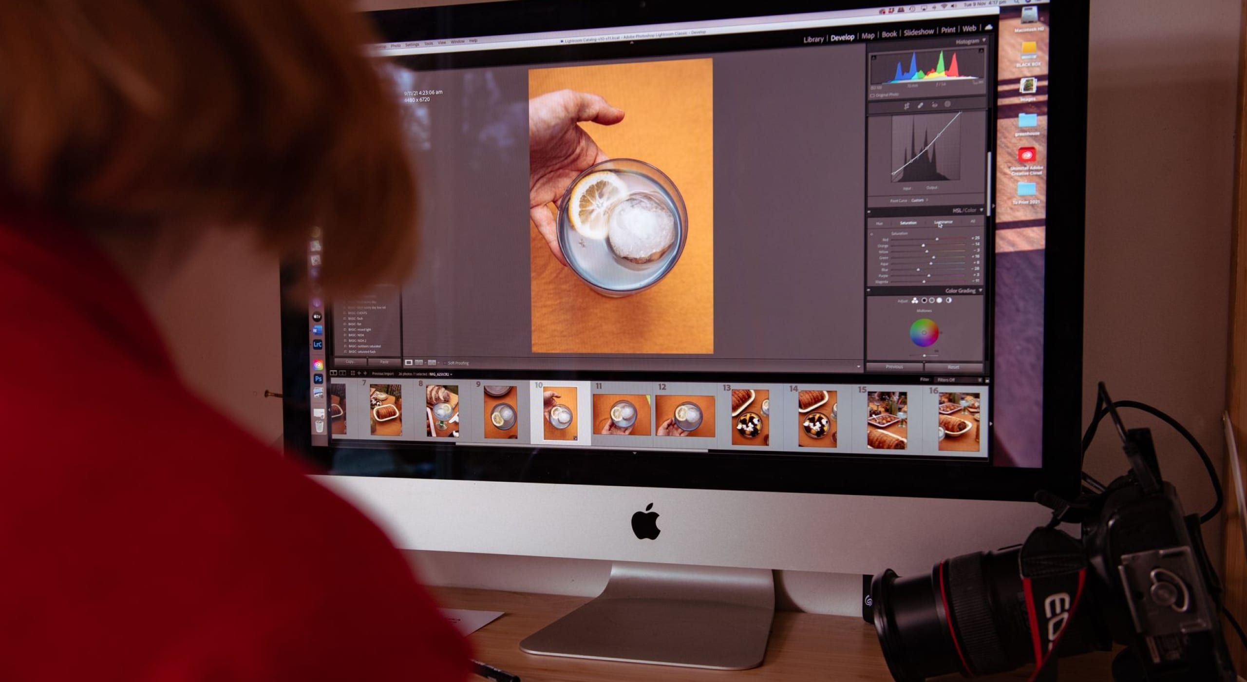 A person editing images on a large monitor