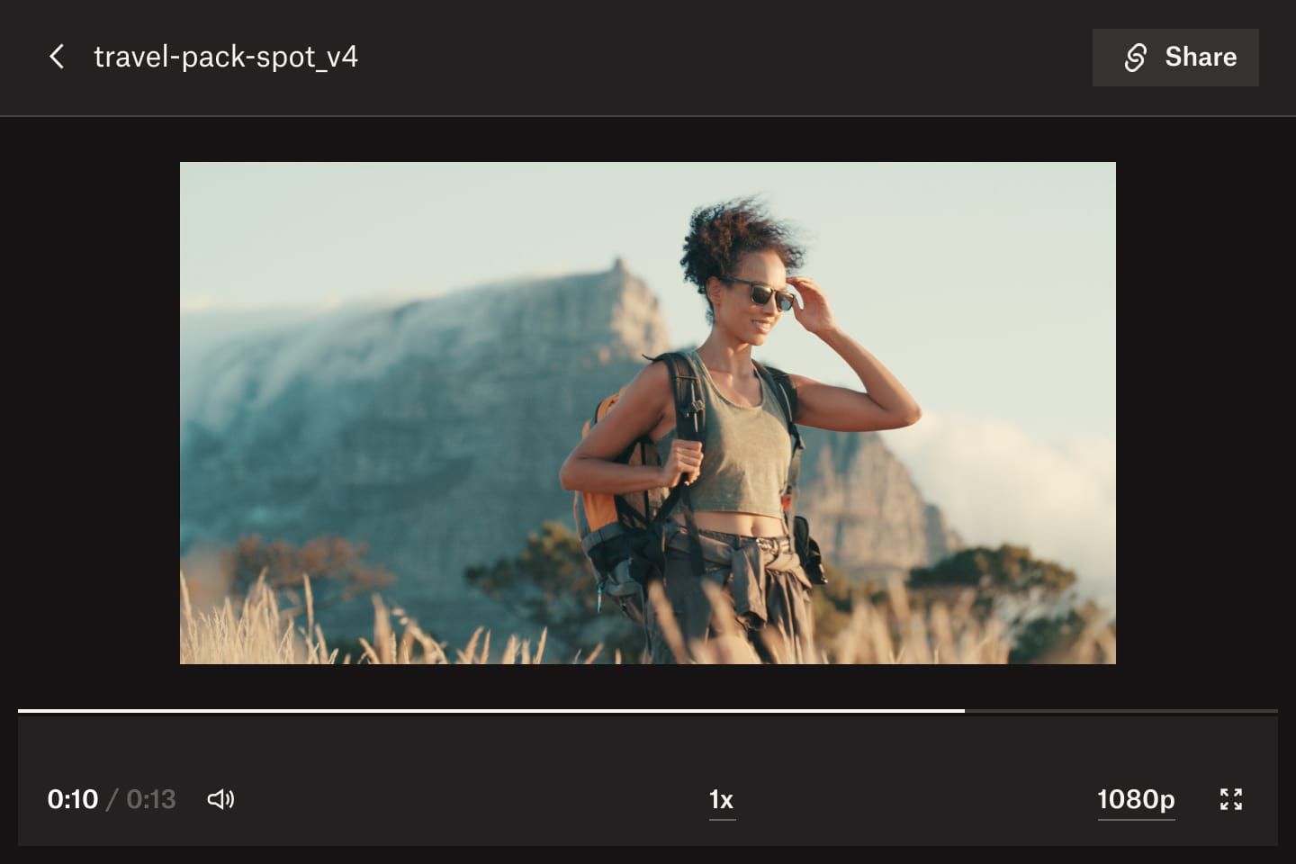A video preview in Dropbox Replay, showing someone walking through a field with a mountainous backdrop.