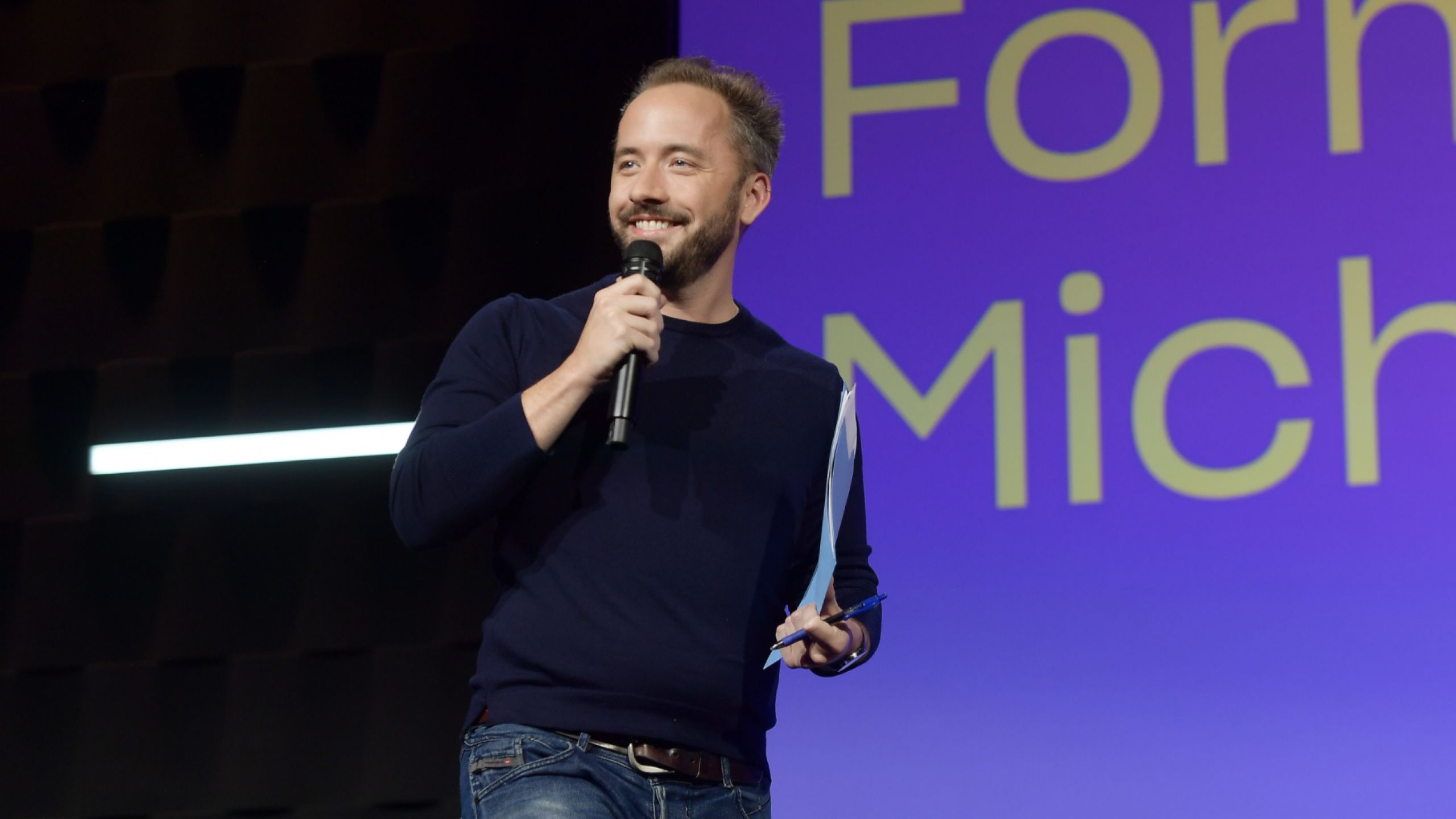 Drew Houston, Co-Founder and CEO of Dropbox, speaks with a microphone. 