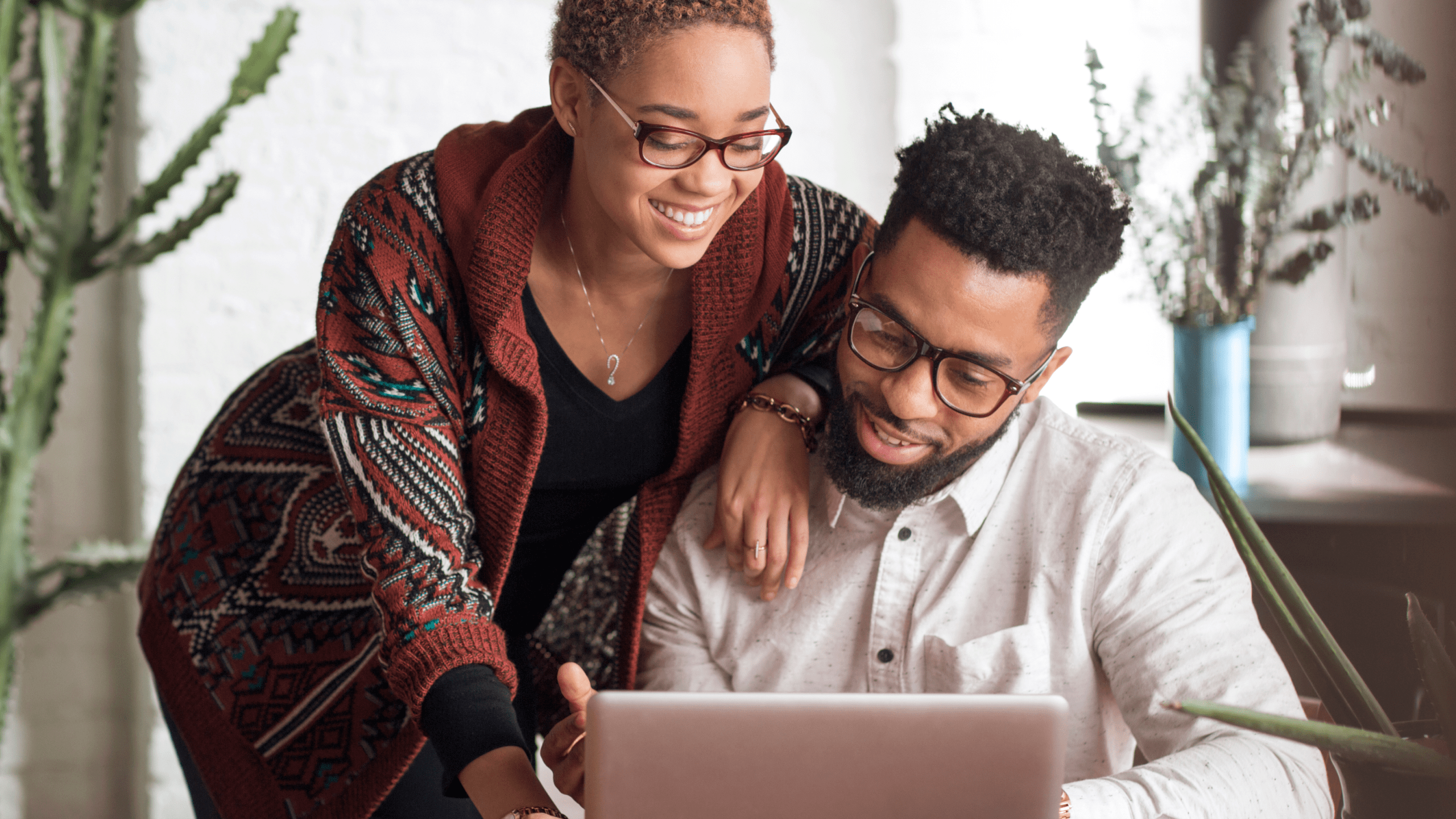 Two family members view files on a laptop