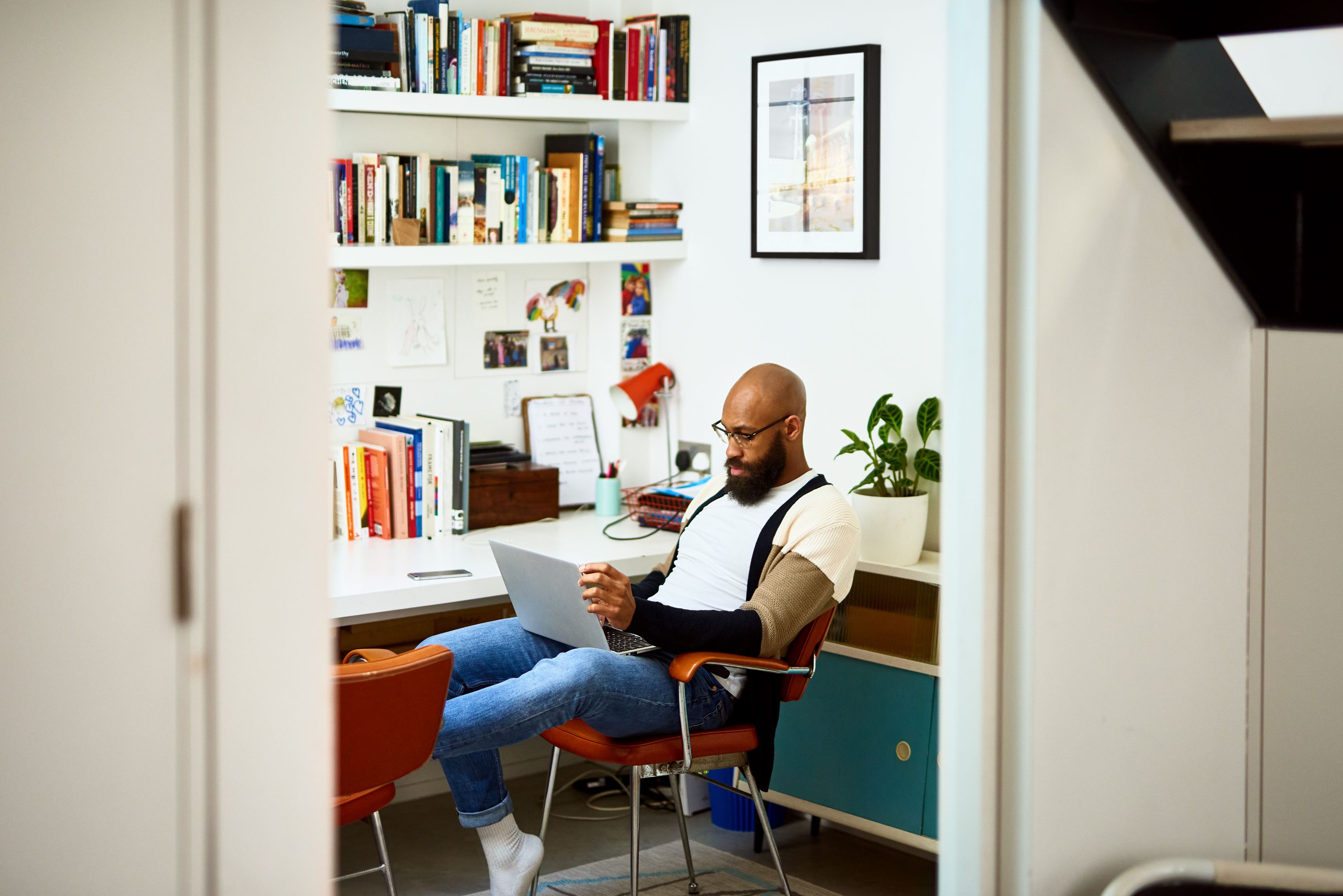A person works from a home office on a laptop.