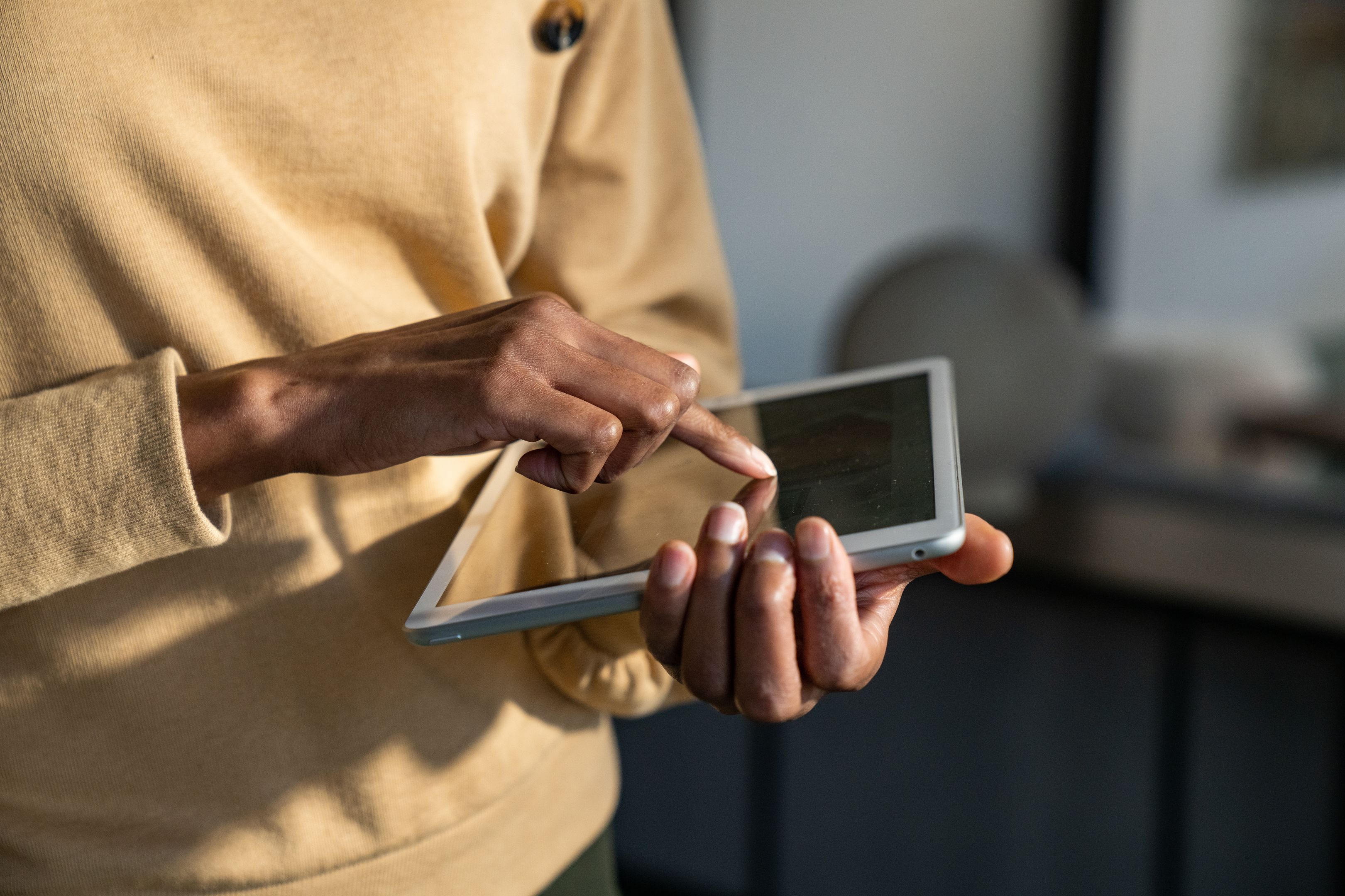 Two hands hold a tablet.