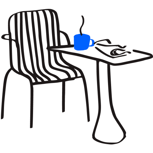 A chair and table with a blue mug on it.
