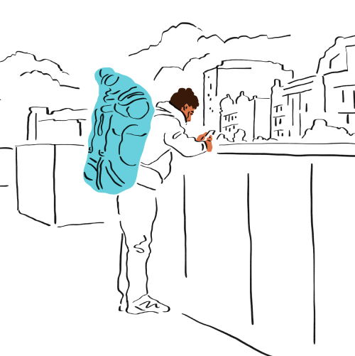 A person on their mobile device wearing a large backpack.