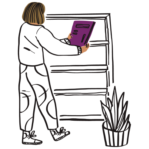 A person holding a purple file in front of an empty bookcase.