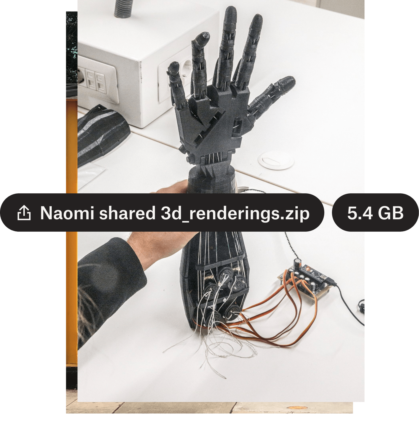 A photo of a robotic hand with the file name and file size overlaid in black text bubbles