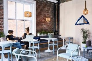 Two people sitting at a table talking.