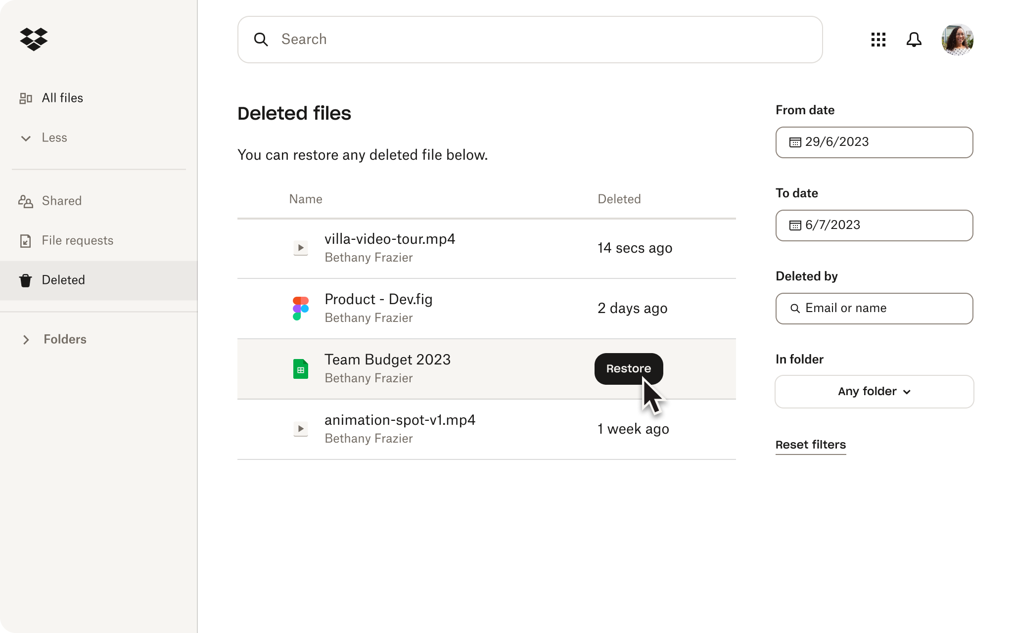 A person using the restore feature in their Dropbox account to recover deleted files.