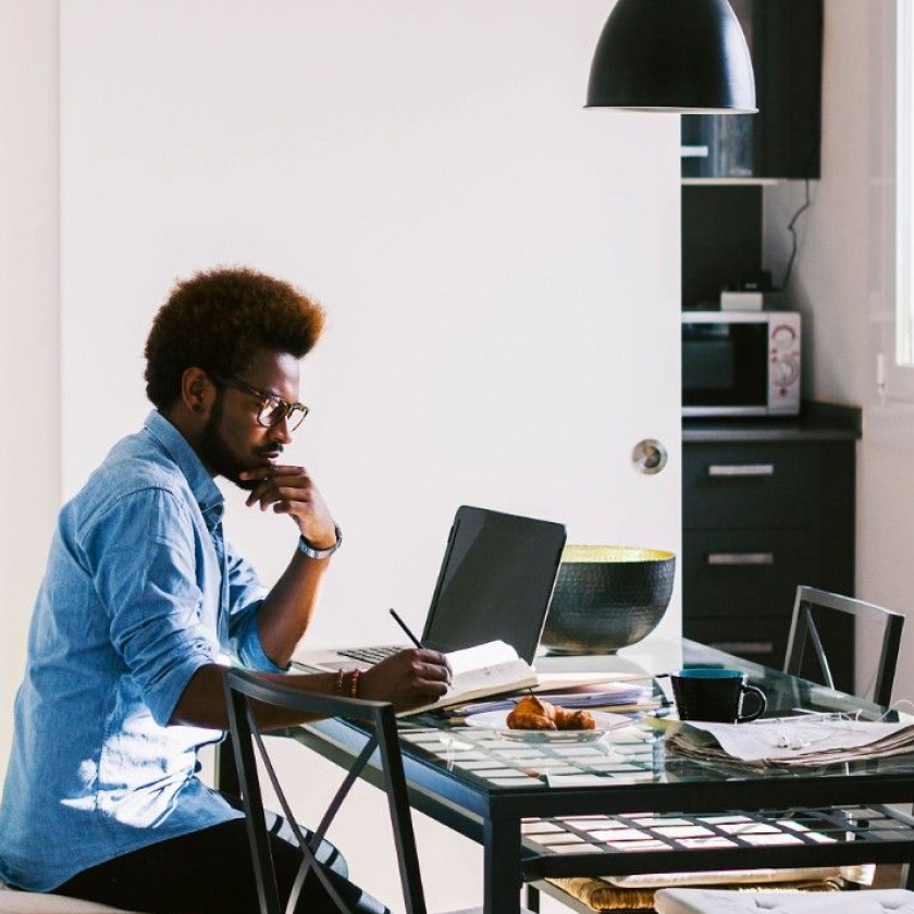 A person works from home at their kitchen table.