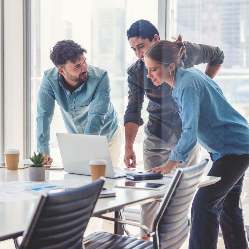 A marketing team talk about their AI marketing workflow in a meeting room.