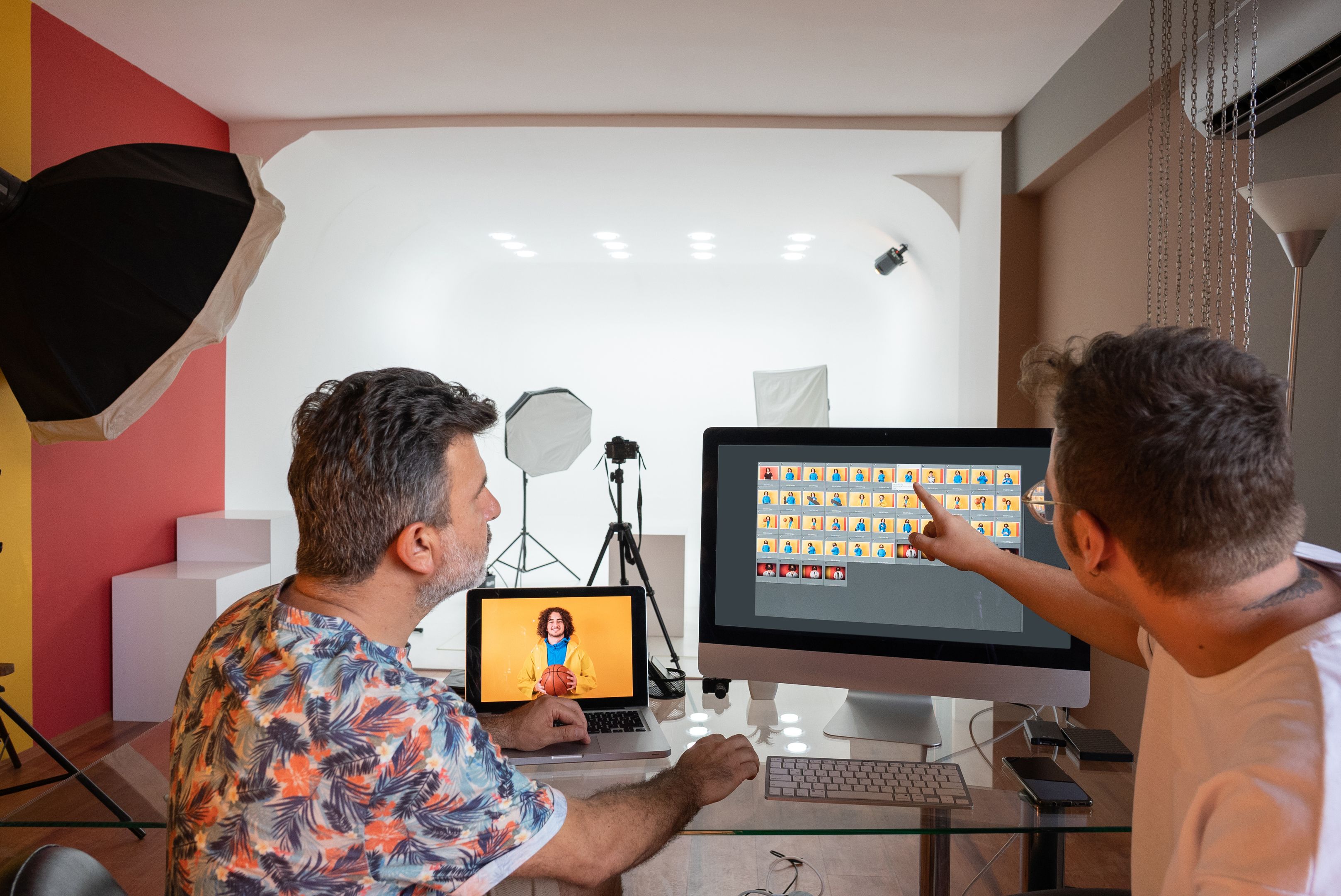 Two creatives work on project files organized in their team cloud storage.