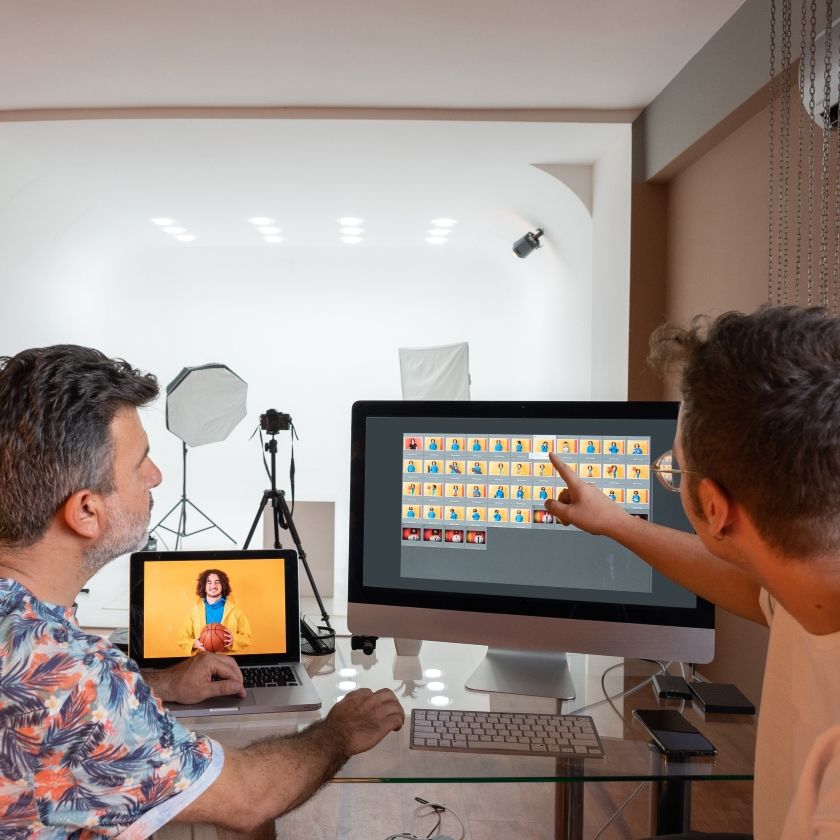 Two creatives work on project files organized in their team cloud storage.