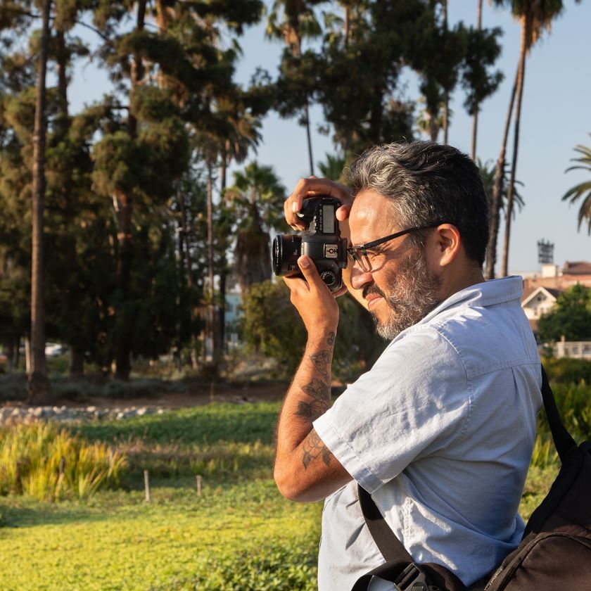 A photographer takes a shot in an outdoor urban environment