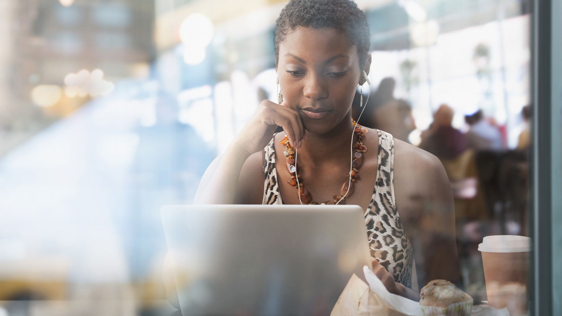 A person organizes their files with an AI assistant while working in a busy cafe.
