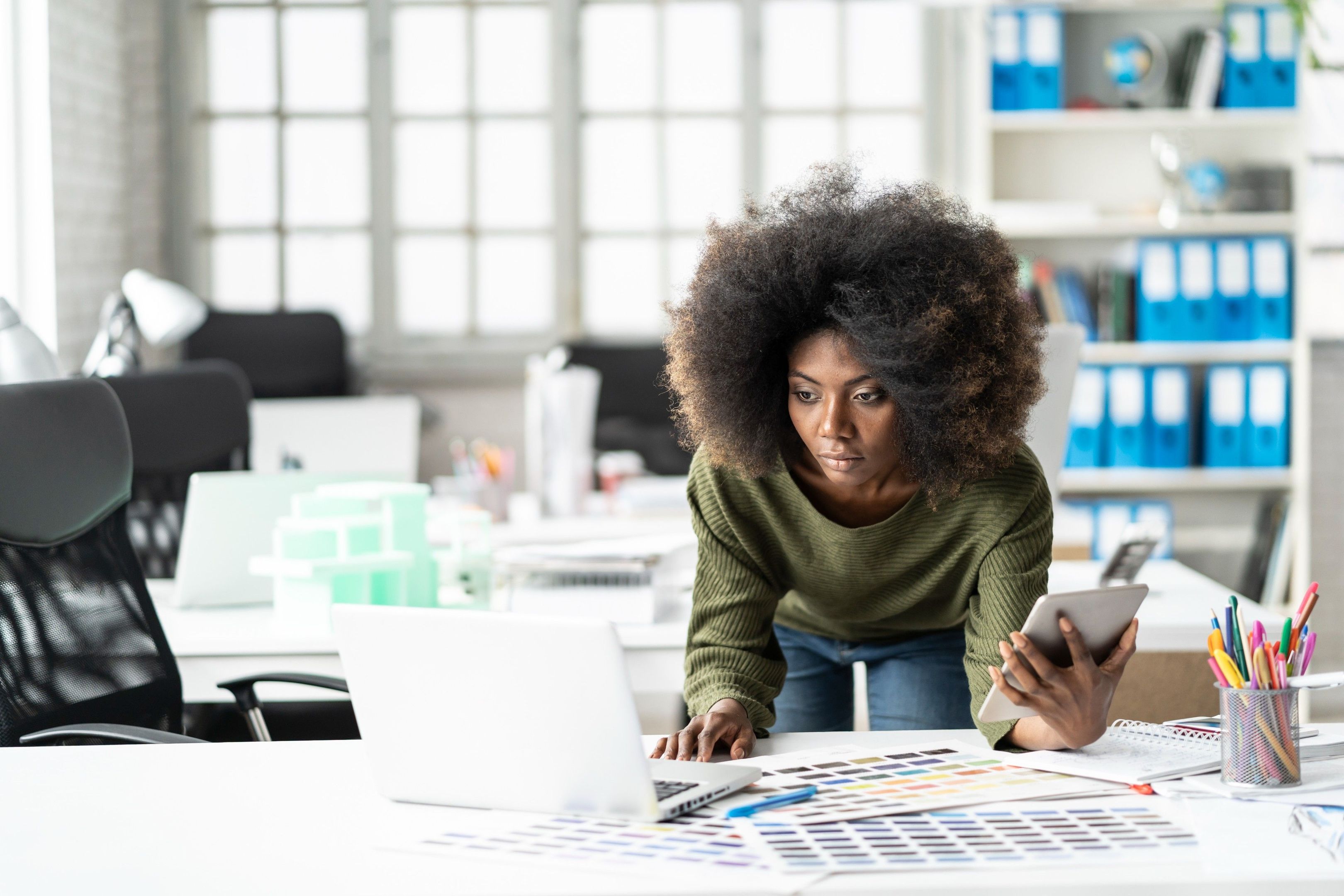 A person sets up Dropbox cloud computer backup services on their laptop while working from home.