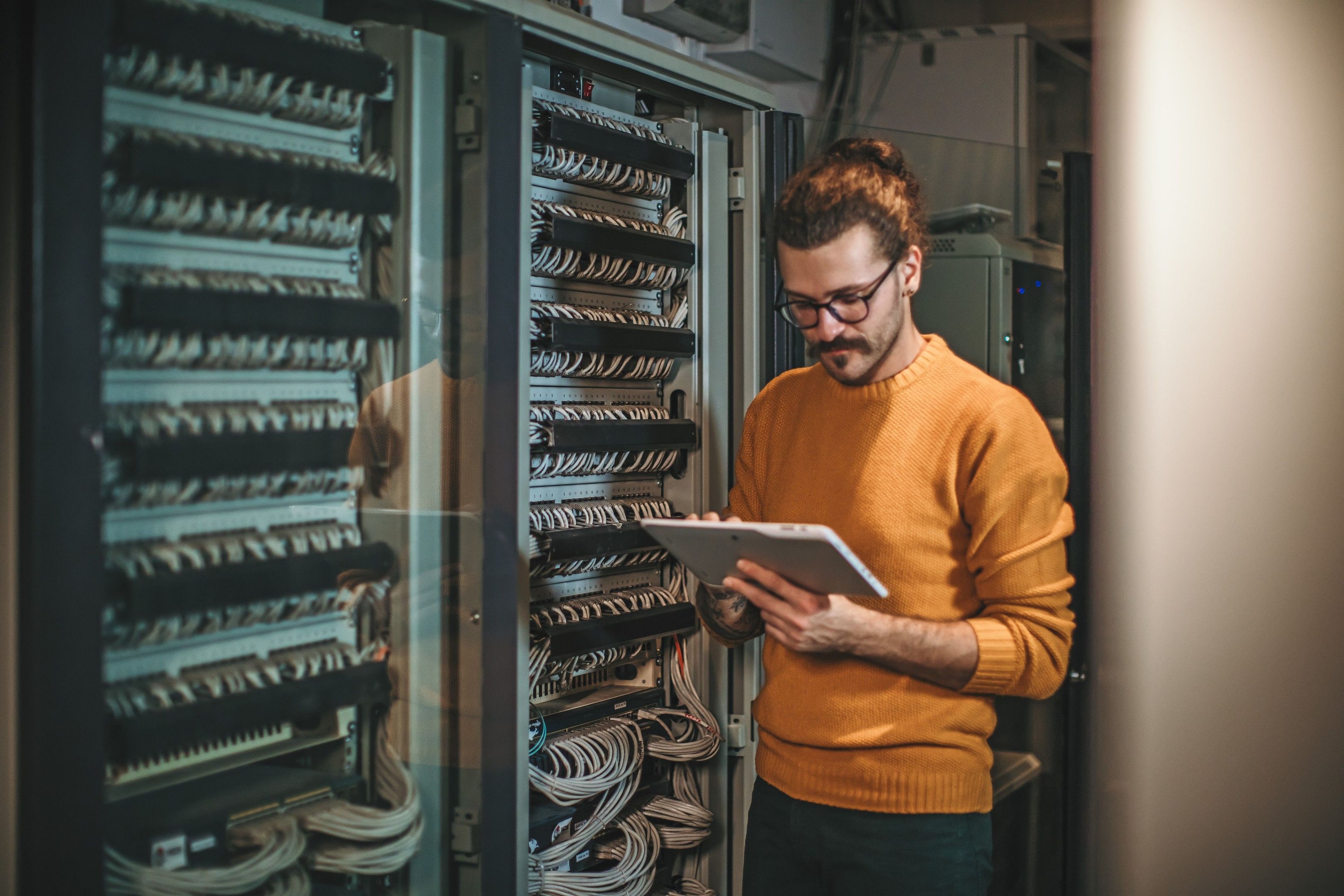 A person inspects an on-premises data storage center.