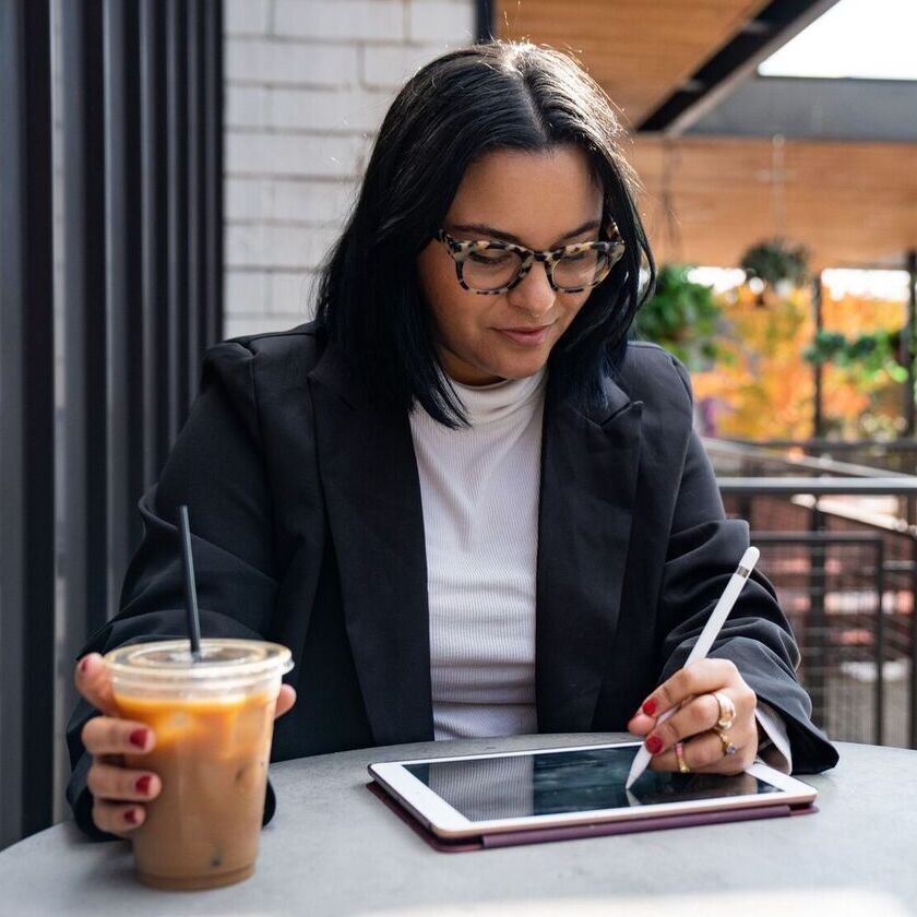 Woman using a pen on an ipad
