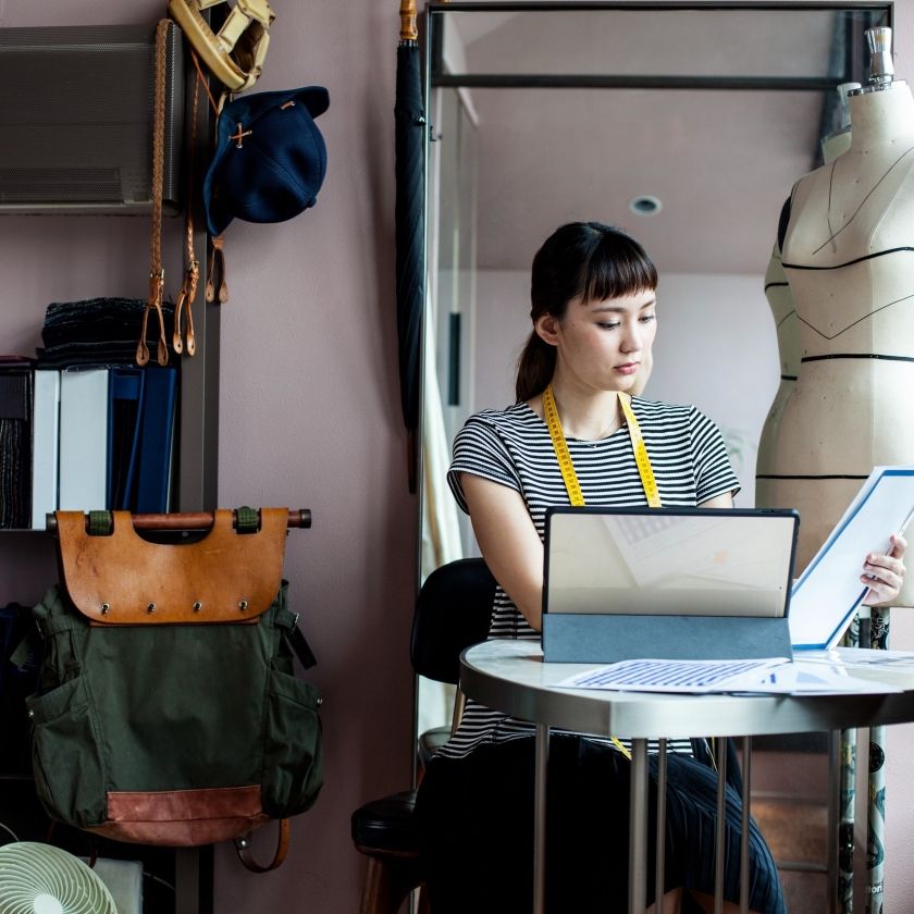 A small business owner prepares files for sharing digitally.