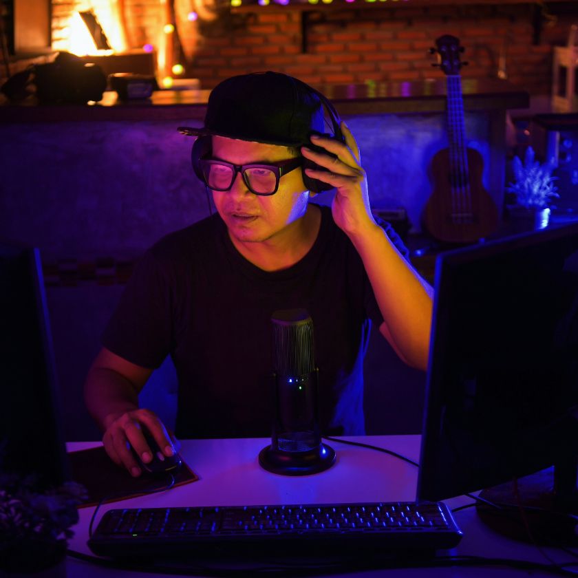 A musician mixes a track on their computer in a studio.