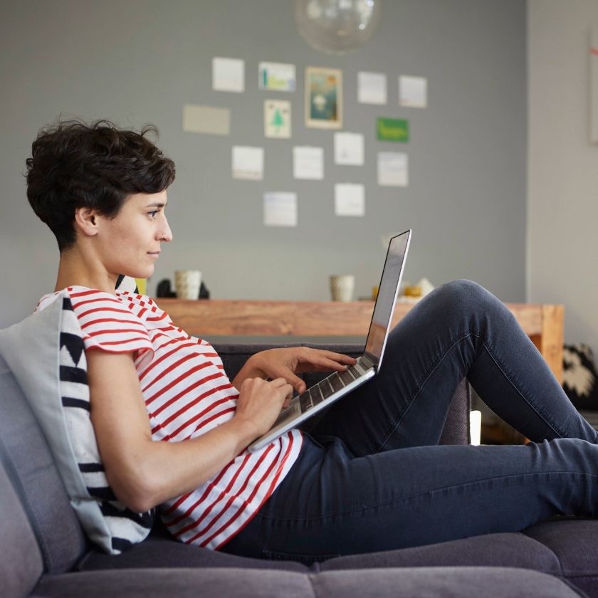 A freelancer works on their laptop at home.