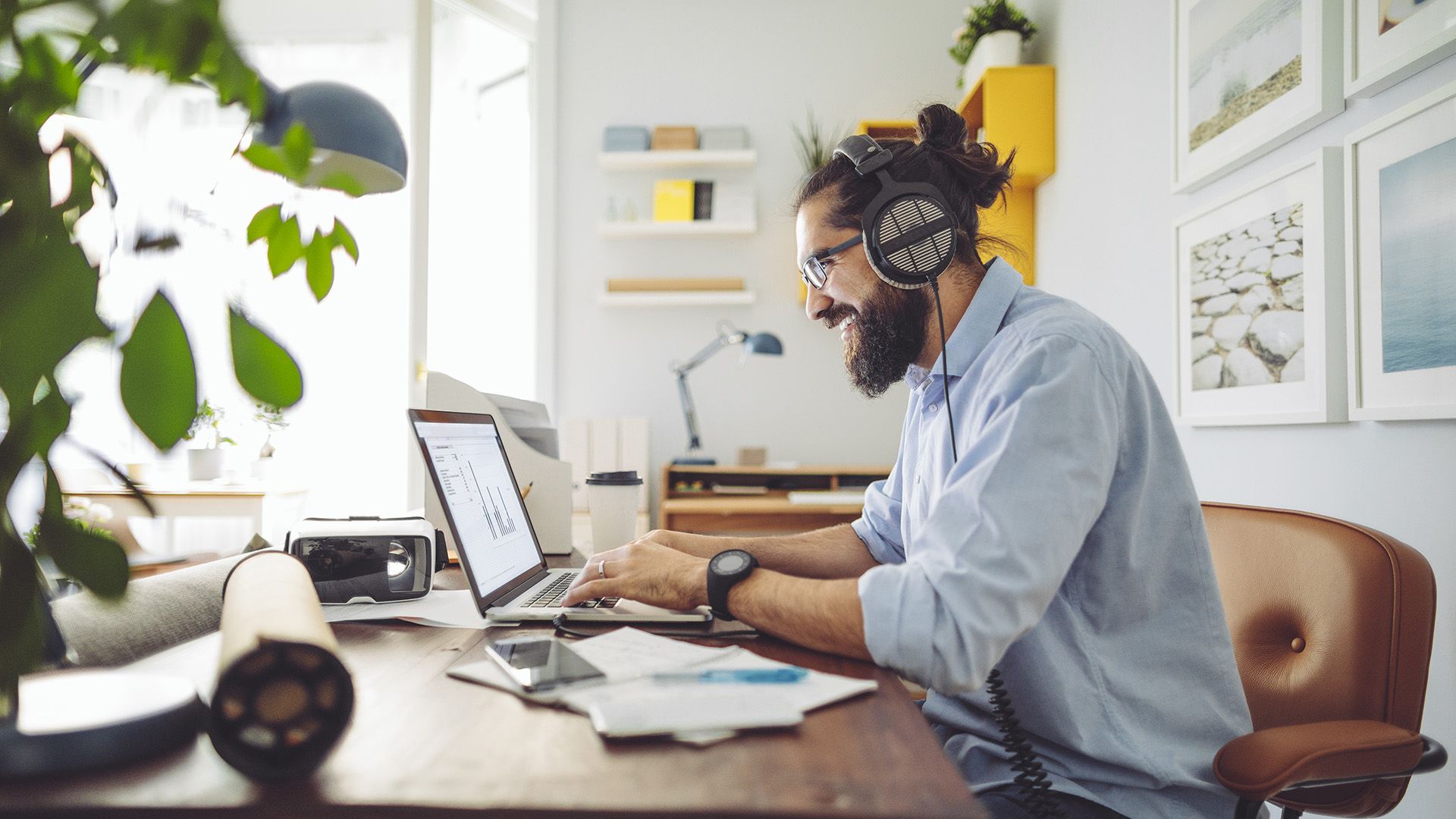 A person smiles after connecting Dropbox to Claude while working from home.