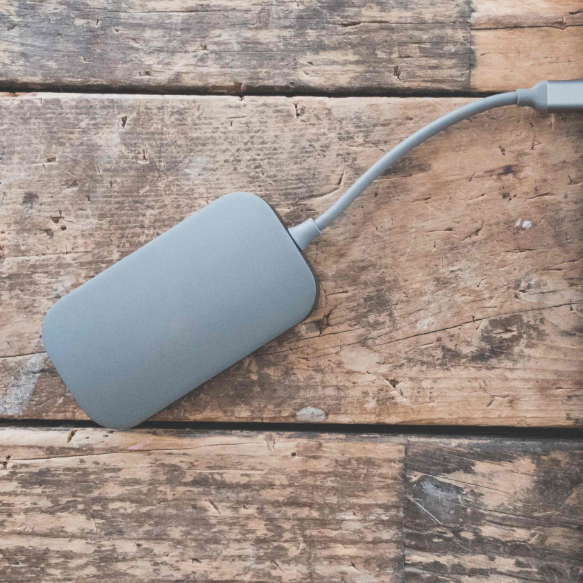 A hard drive is connected to a laptop to backup data.