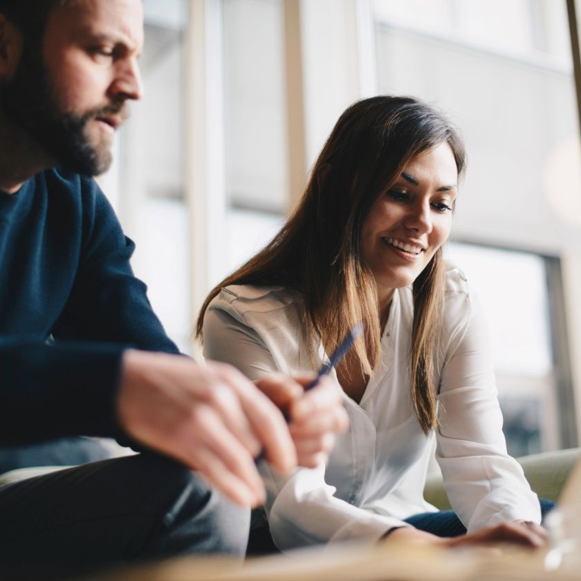 Two colleagues discuss their modular content strategy in a breakout area.