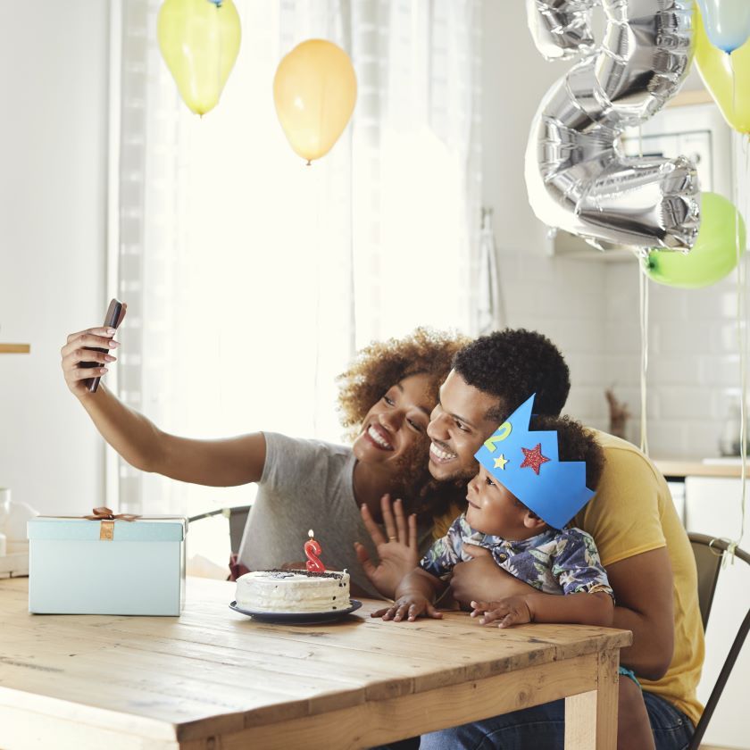 A family takes photos at a birthday celebration and stores them on Dropbox.