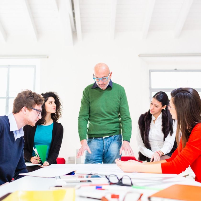 A team collaborates on a project in a meeting room.