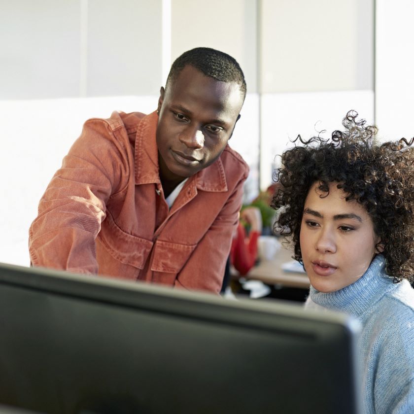 Two coworkers collaborate effectively to increase their team productivity.