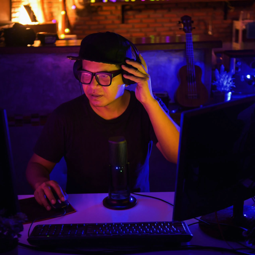 A creative freelancer edits a video project across two monitors.