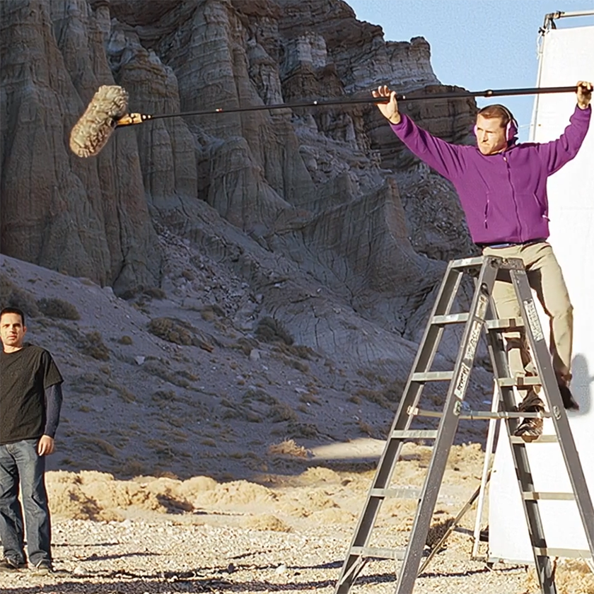 A video marketer monitors equipment during a shoot.