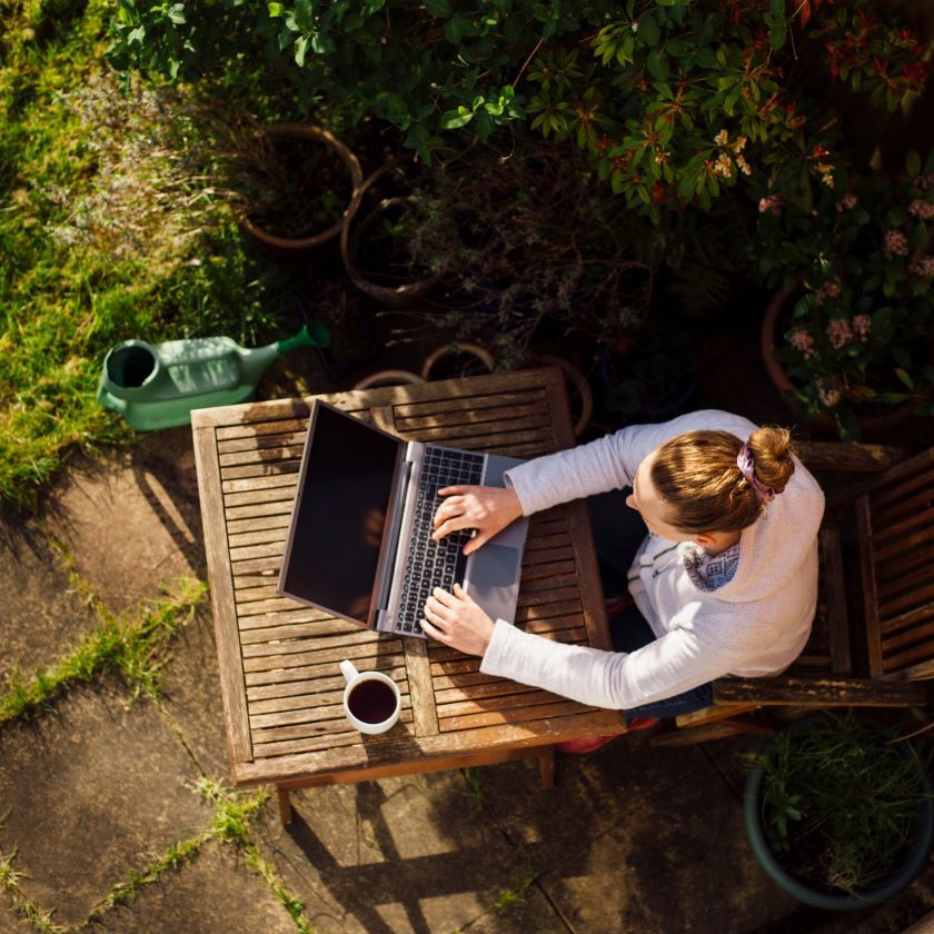 A remote worker uses cloud storage to access their project files while working outdoors.