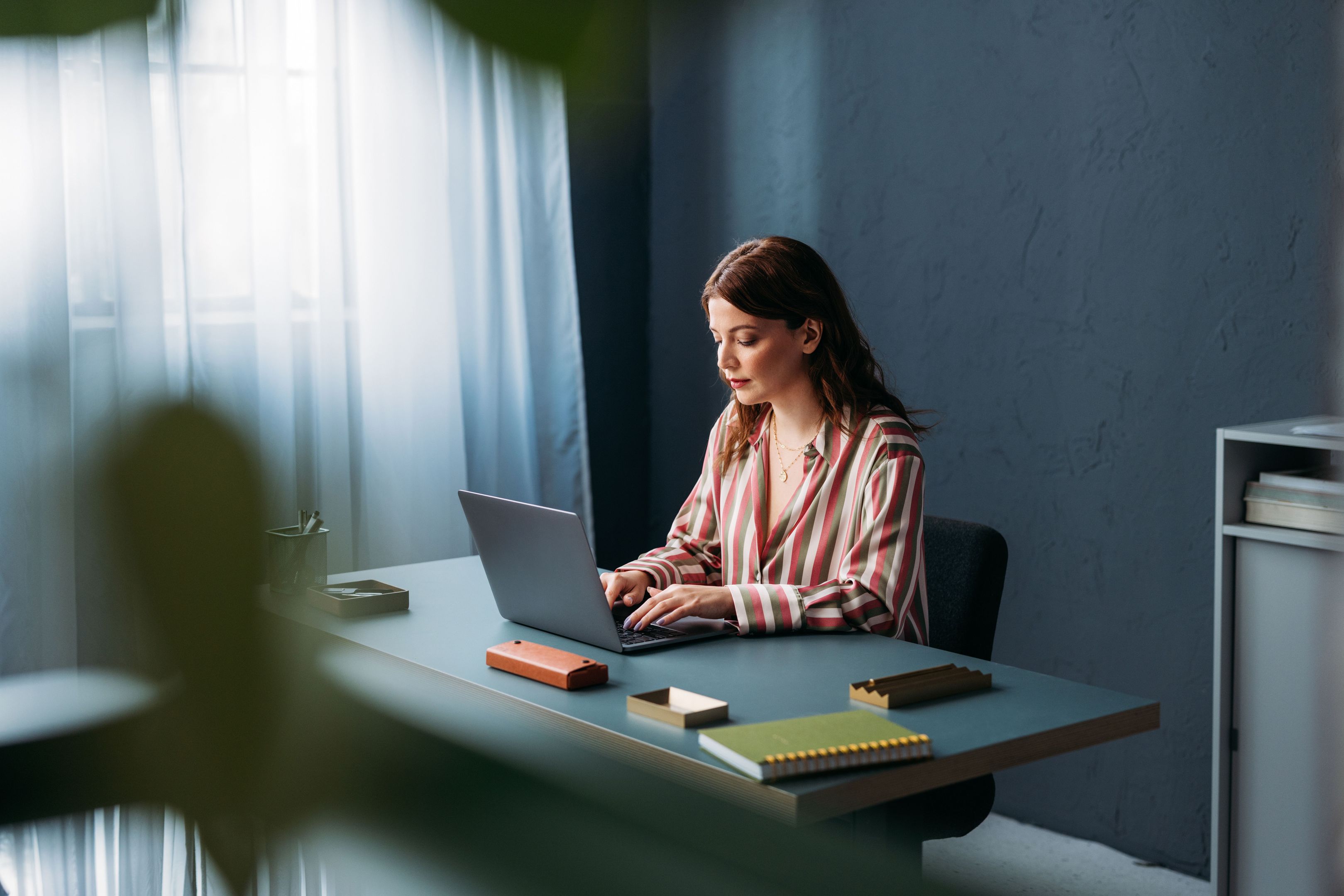 Woman smiling during a conversation at a table in a bright office