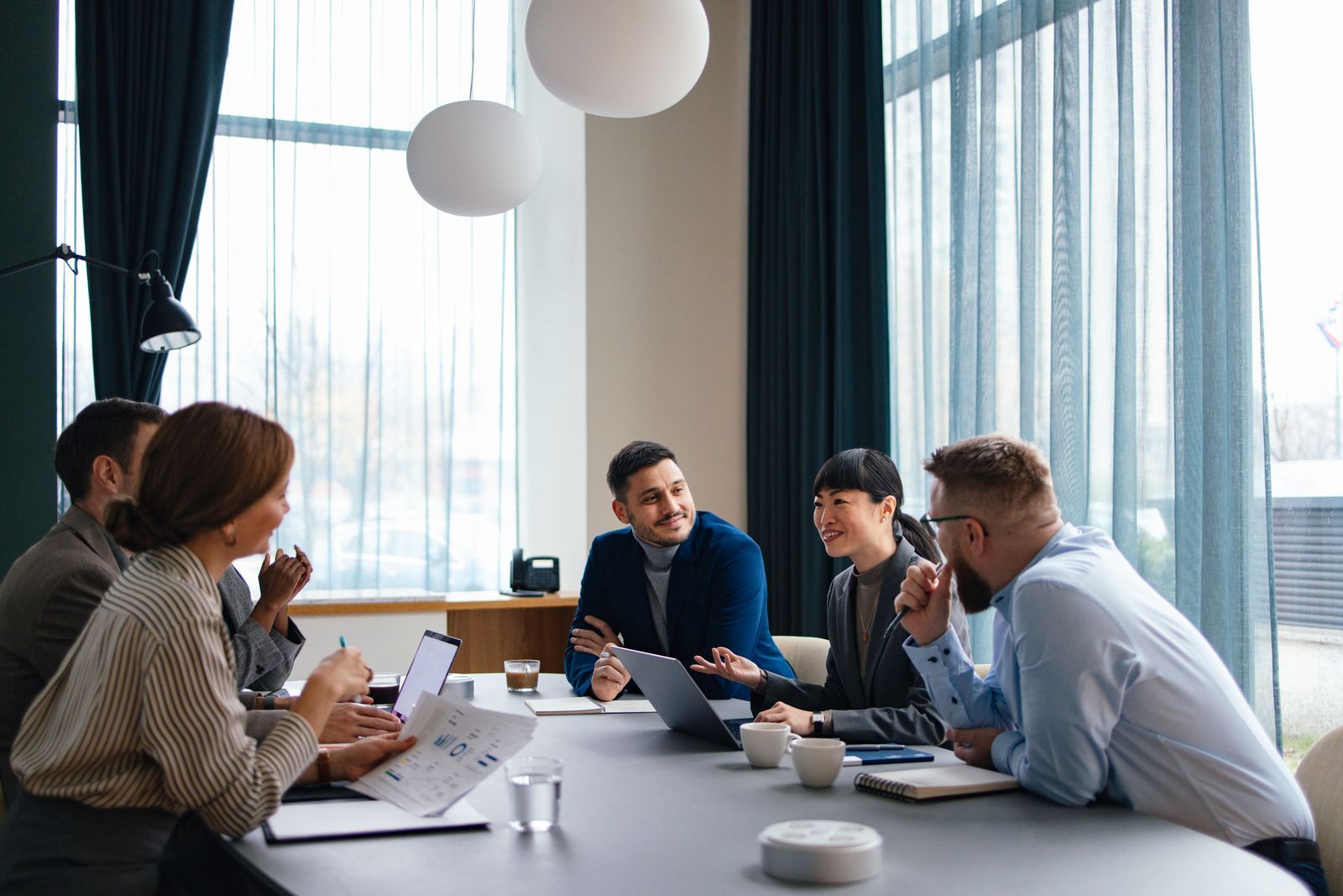 Team meeting around a conference table in a bright office space